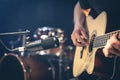 Male musician playing acoustic guitar behind microphone in recording studio. Royalty Free Stock Photo