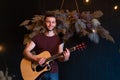 Man with acoustic guitar indoor Royalty Free Stock Photo