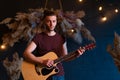 Male musician playing acoustic guitar. Guitarist plays classical guitar on stage in concert Royalty Free Stock Photo