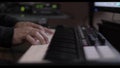 Male musician playing jazz on piano in a recording session taken close up / Hombre tocando piano