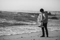 Male musician with a tuba near the ocean. Black and white photo. Royalty Free Stock Photo