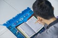 Male muslim reading Koran at home Royalty Free Stock Photo