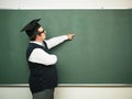 Male nerd showing on blackboard