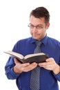 Male nerdy geek is reading a book Royalty Free Stock Photo