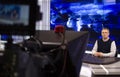 A male News anchor in a broadcast Studio reads text on a teleprompter. Camera in the TV Studio. Royalty Free Stock Photo
