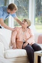 Male nurse assisting retired woman