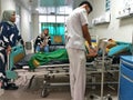 Male Nurse Checking Blood Pressure of A Muslim Pregnant Woman in a Room While the Family Members Are Watching