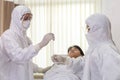 Male nurse and doctor wearing ppe suit and facemask perform Coronavirus COVID-19 PCR test. patient nasal NP and oral OP swab Royalty Free Stock Photo