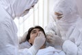 Male nurse and doctor wearing ppe suit and facemask perform Coronavirus COVID-19 PCR test. patient nasal NP and oral OP swab Royalty Free Stock Photo