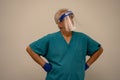 Male nurse with face mask shield and hands on hips akimbo Royalty Free Stock Photo