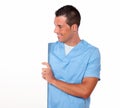 Male nurse holding and looking at white placard Royalty Free Stock Photo