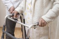 The nurse helps the old woman to walk with rehabilitation walker Royalty Free Stock Photo