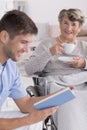 Male nurse reading a book to senior Royalty Free Stock Photo