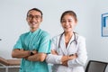 a male nurse standing beside the female doctor with hand crossed