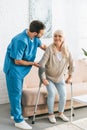 male nurse supporting smiling senior woman