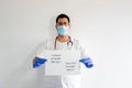 A male nurse wearing a mask, gloves and stethoscope.