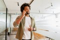 Male office employee having phone conversation, connecting with customers. Confident African-American man in smart Royalty Free Stock Photo