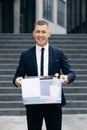 Male office worker with box of personal stuff resigns from his job. Concept of dismissal from work, recruitment