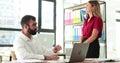 Male office worker gestures to emphasize key points to colleague