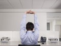 Male Office Worker Stretching At Desk Royalty Free Stock Photo