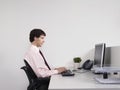 Male Office Worker Using Computer At Desk