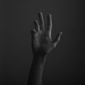 Male open hand gesture on a dark background