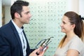 Male ophthalmologist and female patient in optics store