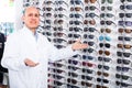 Male ophthalmologist in optics store