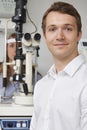 Male Optician Giving Female Patient Eye Examination