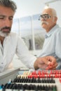 Male optometrist examining senior patients eyes