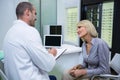 Male optometrist talking to female patient Royalty Free Stock Photo