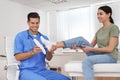 Male orthopedist fitting insole on patient`s foot