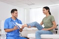 Male orthopedist fitting insole on patient`s foot Royalty Free Stock Photo