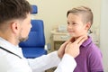 Male otolaryngologist examining little child