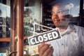 Male Owner Of Coffee Shop Or Restaurant Turning Round Closed Sign On Door Of Failed Business Royalty Free Stock Photo