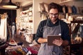 Male Owner Of Gift Store With Digital Tablet