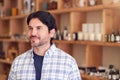 Male Owner Of Gift Store Standing In Front Of Shelves With Cosmetics And Candles Royalty Free Stock Photo