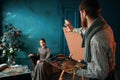 Male painter paints womans portrait Royalty Free Stock Photo