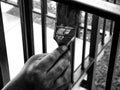 Black and white finished painter`s hand with brush painting steel corridor railing. selective focus. Royalty Free Stock Photo