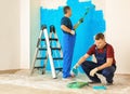 Male painters in uniform working indoors