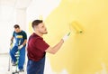 Male painters in uniform working indoors