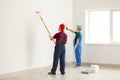 Male painters in uniform working indoors