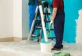 Male painters in uniform working indoors