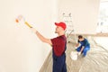 Male painters in uniform working indoors