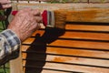 Close up. Male painting wooden maltese window.