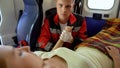 Male paramedic holding patient's hand, medical care and moral support, kindness