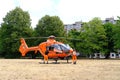 male paramedics go to modern Red medical helicopter, emergency aircraft Germany on helipad, Air medical services, Rapid Response