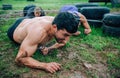 Male participant in an obstacle course crawling