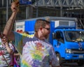 A male participant of the paradewith `We are proud` slogan