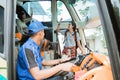 a male passenger boarded the bus with a waving hand when he met his group of friends Royalty Free Stock Photo